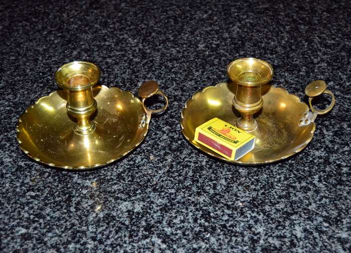 A pair of vintage solid brass candle holders
