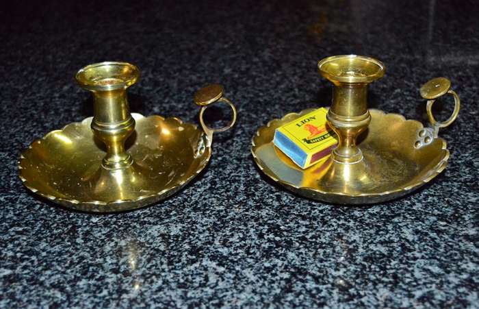 A pair of vintage solid brass candle holders