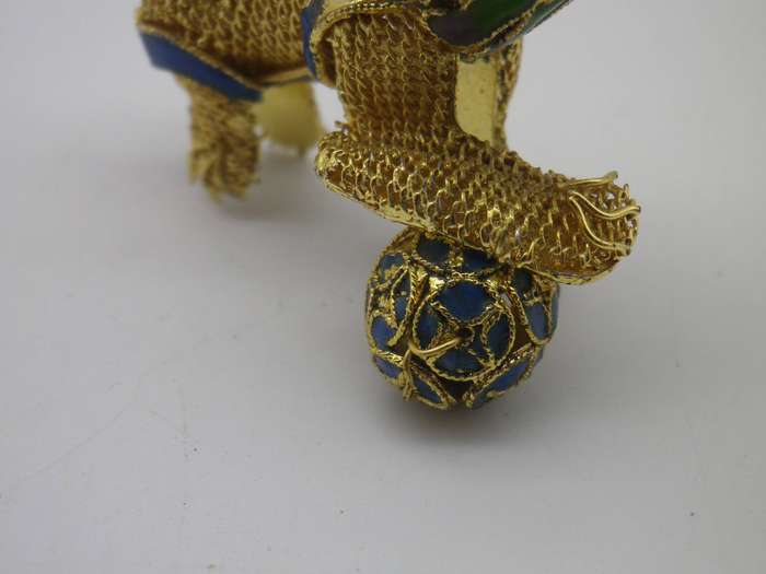Miniature enamel & gold tone metal articulated FOO DOG with ball.