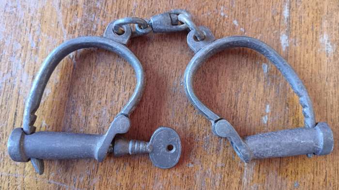 Victorian Hiatt iron handcuffs with key - working