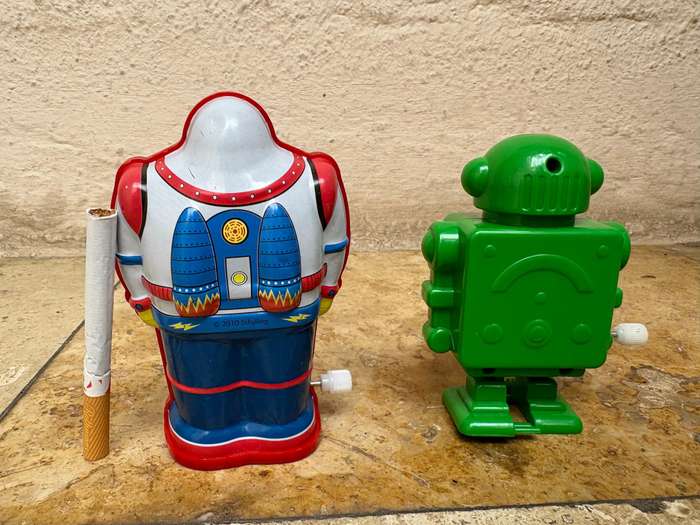 Retro tin Schylling Rowley wind up tin robot , pvc green wind up robot pair