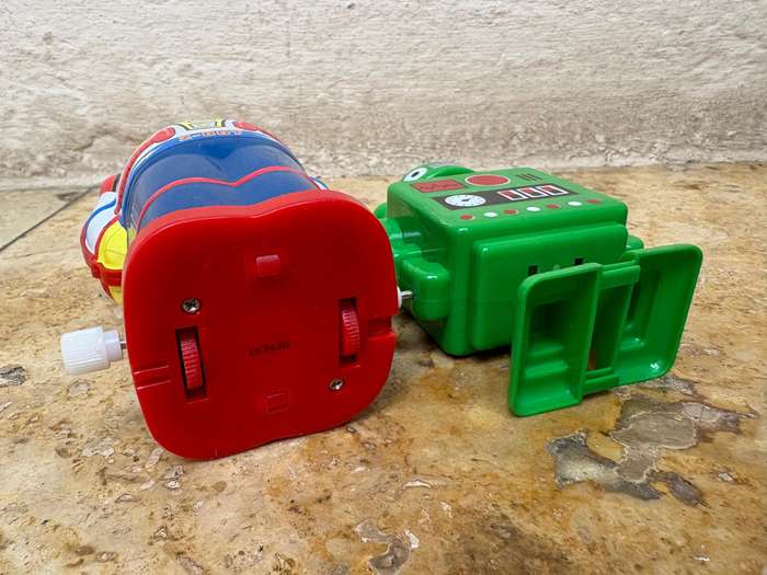 Retro tin Schylling Rowley wind up tin robot , pvc green wind up robot pair