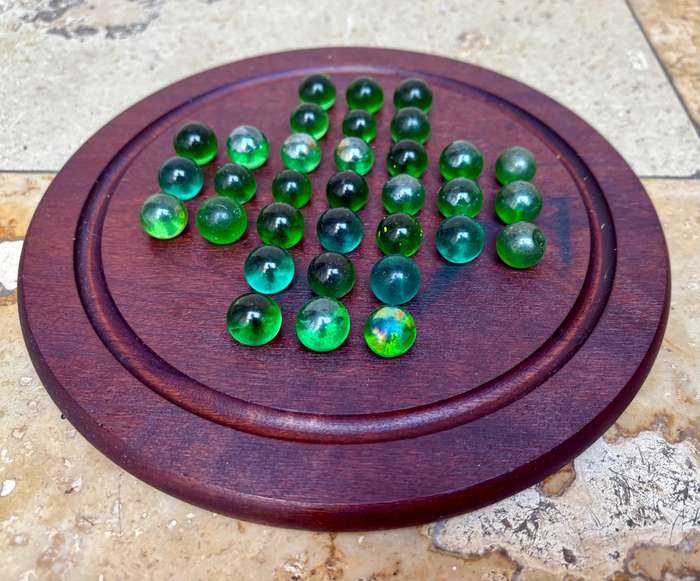 Solitaire game wood green glass marbles