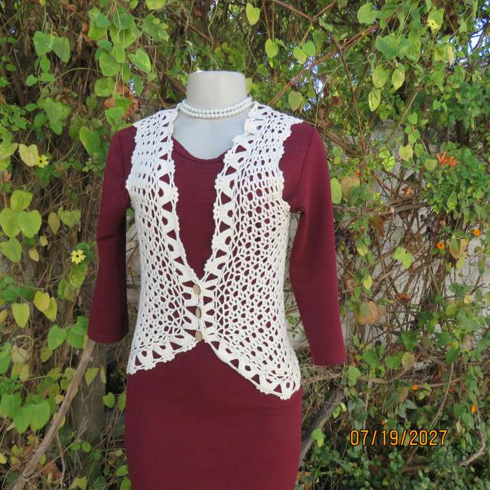 White elegant crochet waistcoat with round edging. The button closure. Size 34-36