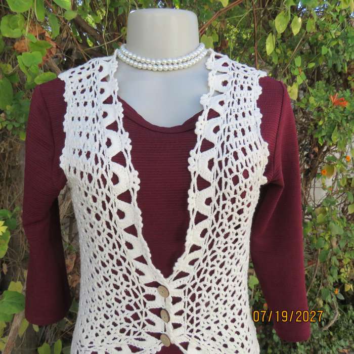 White elegant crochet waistcoat with round edging. The button closure. Size 34-36