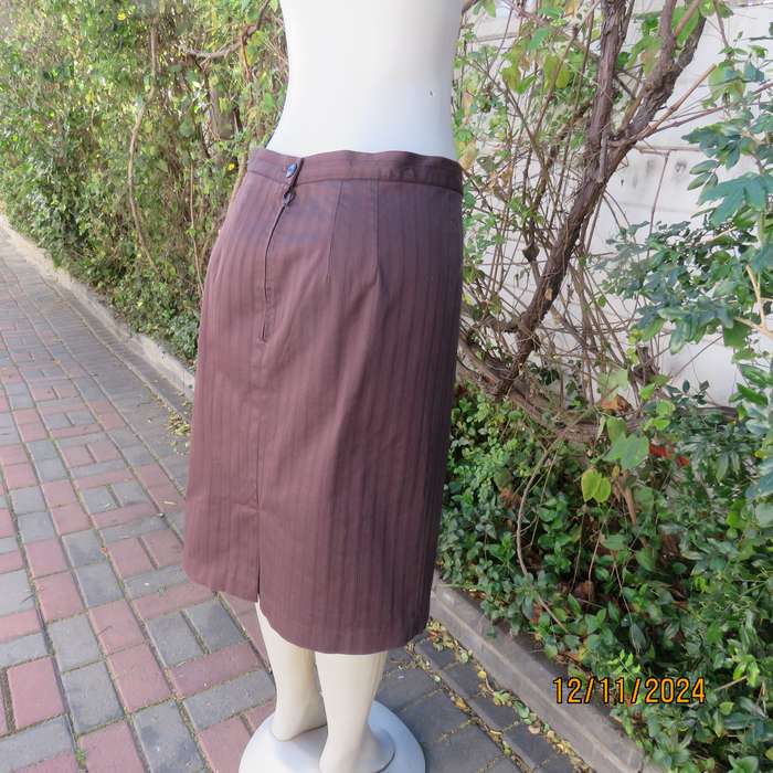 Dark brown striped firm textured stretch polyester pencil lined skirt.Size 38.Zip/pleat at back.