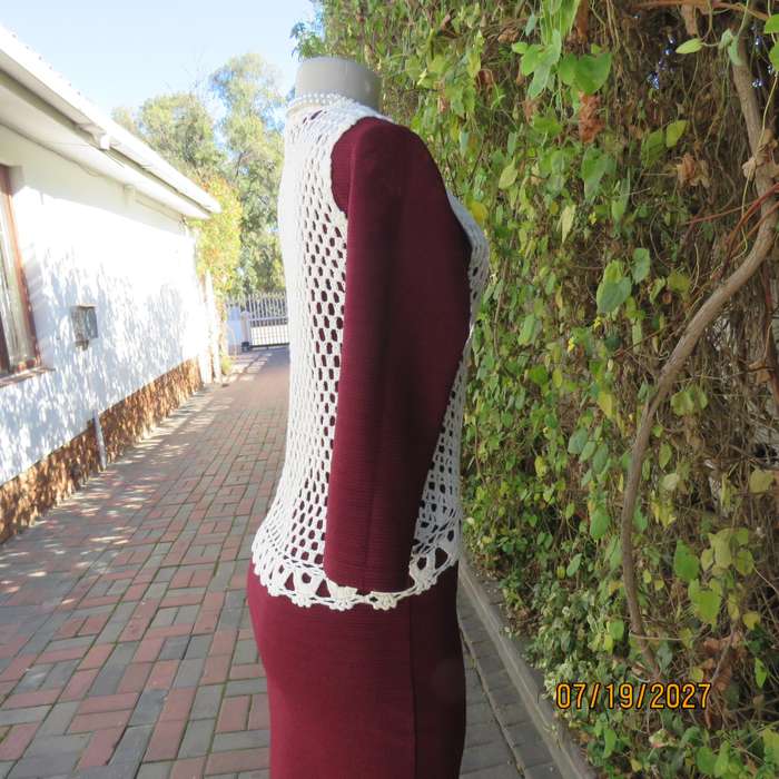 White elegant crochet waistcoat with round edging. The button closure. Size 34-36