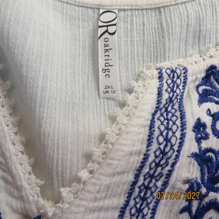 White creased cotton slip over short sleeve top. Blue embroidered front yoke. Size 36