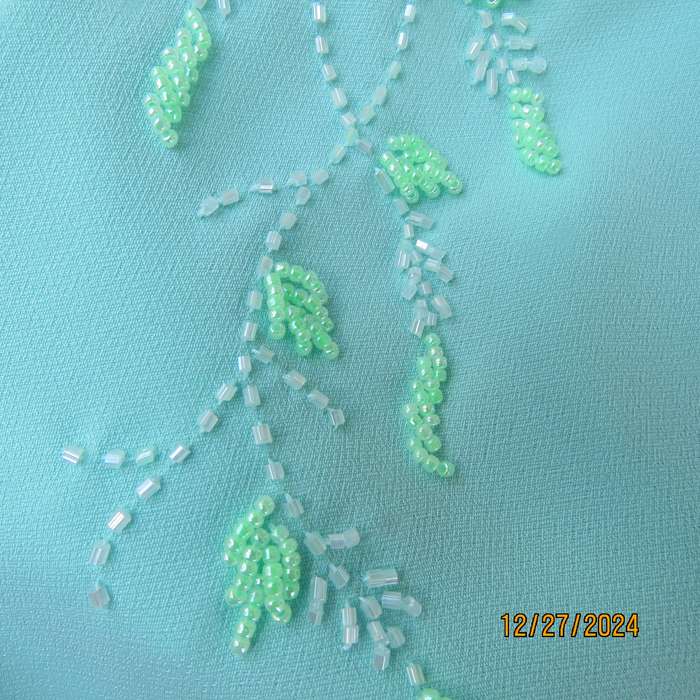 Beautiful emerald green embellished polyester top with shoulder straps. Size 37.Button down back.