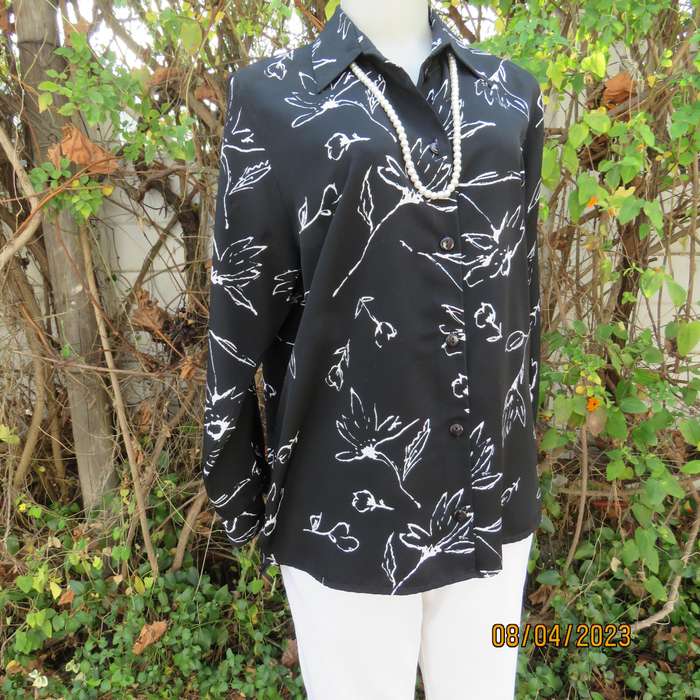 CONCEPTS black silky polyester top with white graphic floral print. Size 40.