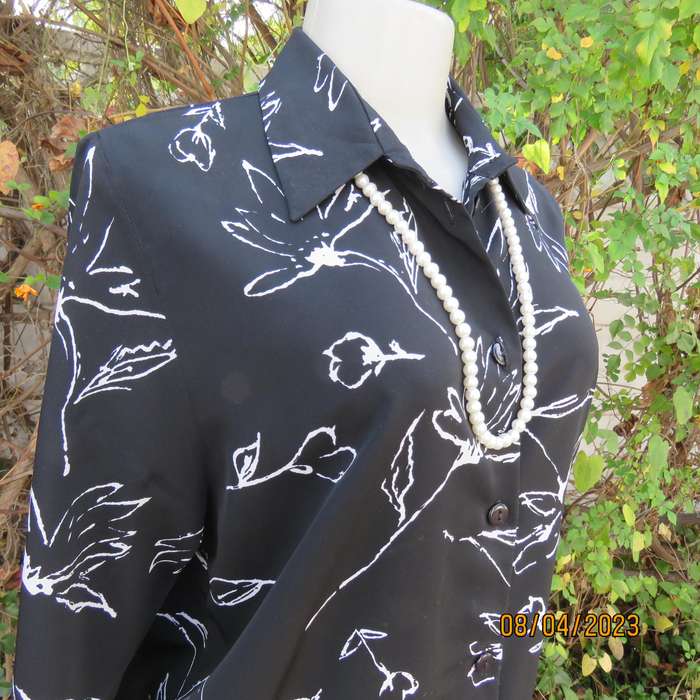 CONCEPTS black silky polyester top with white graphic floral print. Size 40.