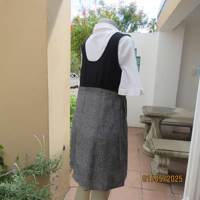 Unique pinafore with black stretch polyester top/black and white striped woolen bottom.Size 36.