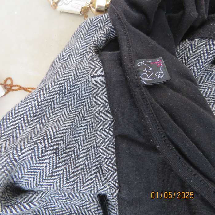 Unique pinafore with black stretch polyester top/black and white striped woolen bottom.Size 36.