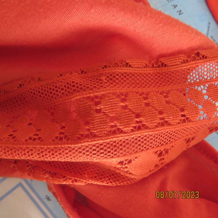 Burnt orange long sleeve stretch polyester slip over top size 44. Shoulder lace inlays.