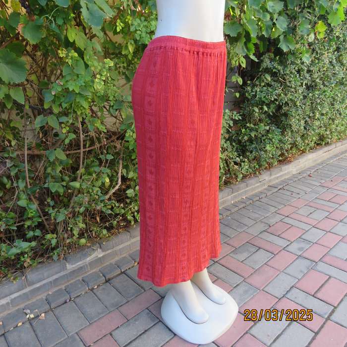 Burnt orange colour ankle length crinkled polycotton size 36 skirt with  embossed patterns.