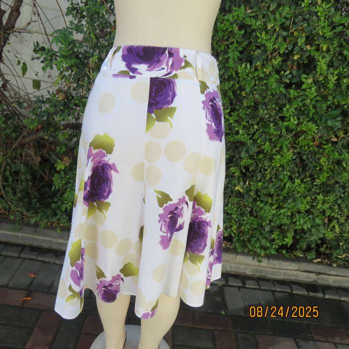 White polycotton paneled A-line skirt with purple-green bold flowers. Size 34-36