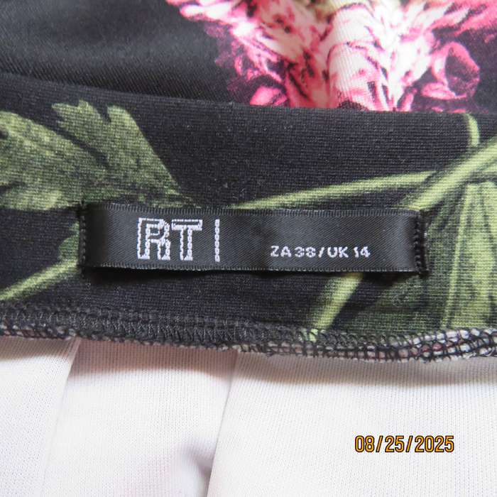 Black firm stretch polyester with red-pink floral print. With box pleats. Size 36