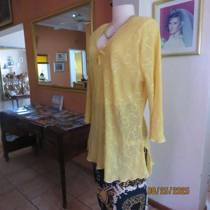 Golden yellow slightly creased embroidered polyester long top. Size 40