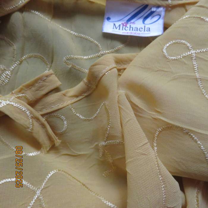 Golden yellow slightly creased embroidered polyester long top. Size 40