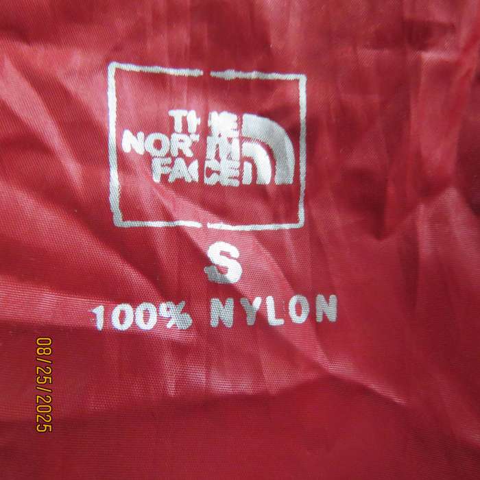 THE North Face red nylon windbreaker size 36 with hood and drawstrings.