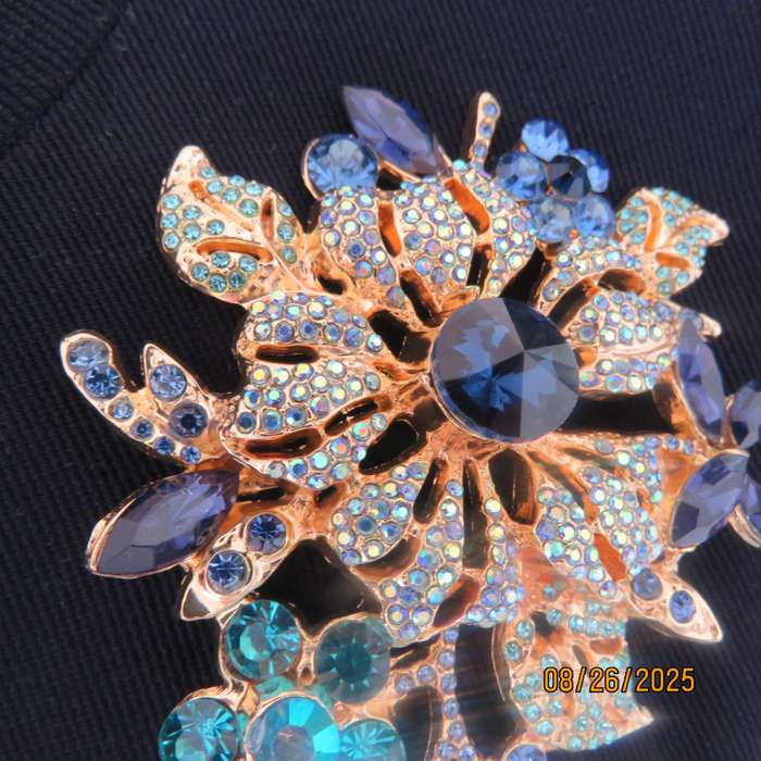 Blue stone on golden base very large brooch-decoration. 6 different stones. New