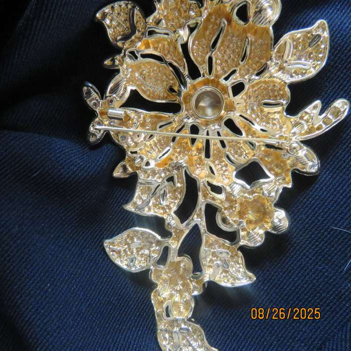 Blue stone on golden base very large brooch-decoration. 6 different stones. New