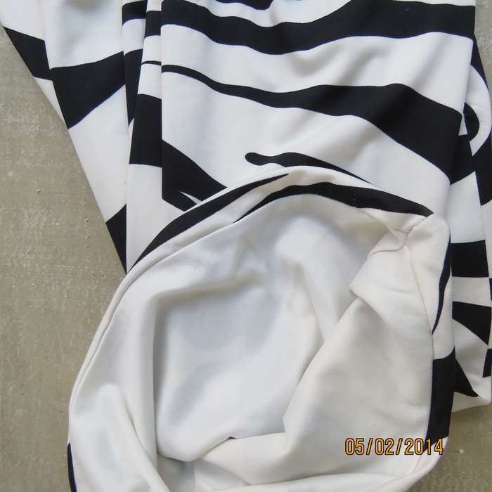 Fabulous black-white animal print stretch polyester XS dress.Size 28.Two layers. Pleats in waist.RT.