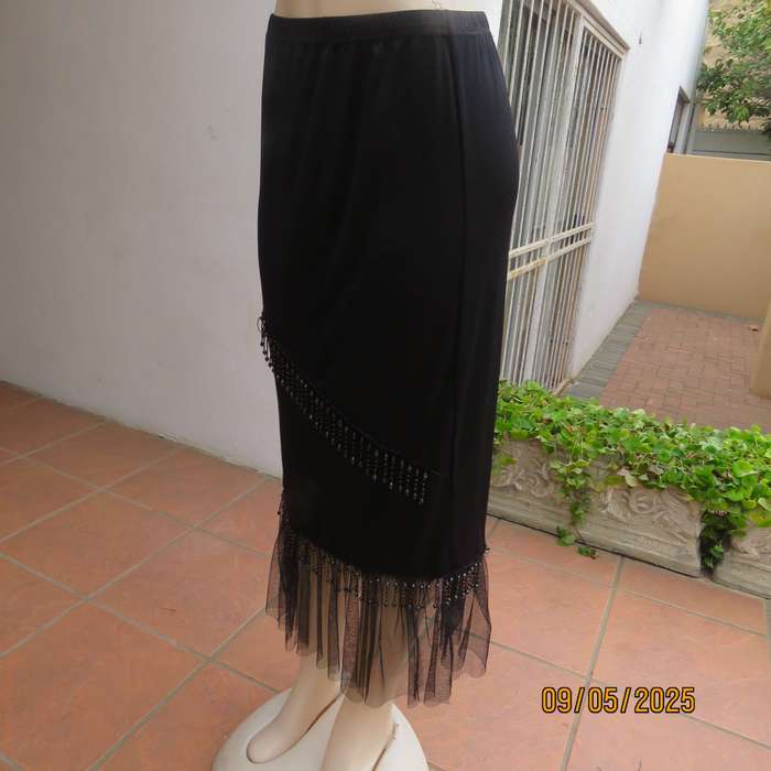 Black stretch polyester ankle length skirt with elastic waist. Netting and beads. Size 36