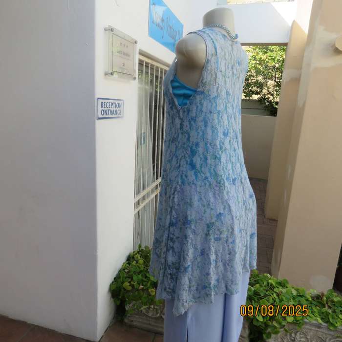 Light blue stretch acrylic lace high-low long top in floral pattern size 36.