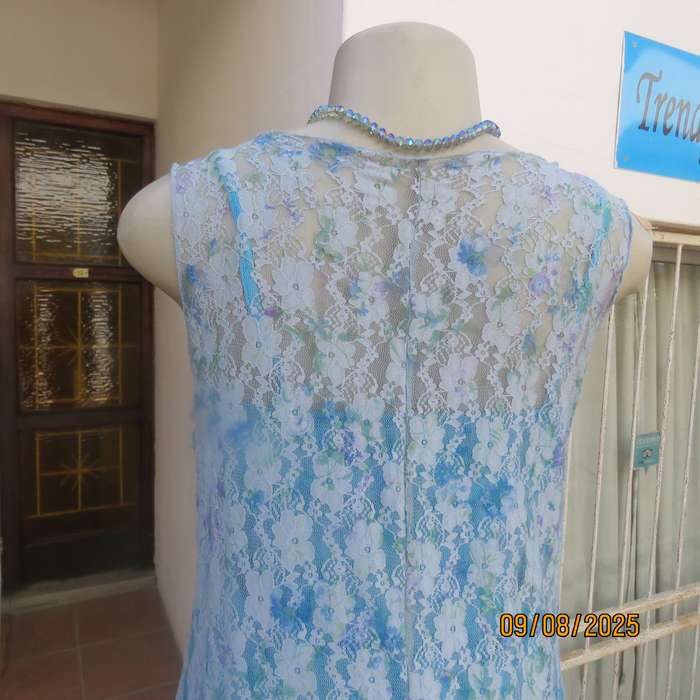 Light blue stretch acrylic lace high-low long top in floral pattern size 36.