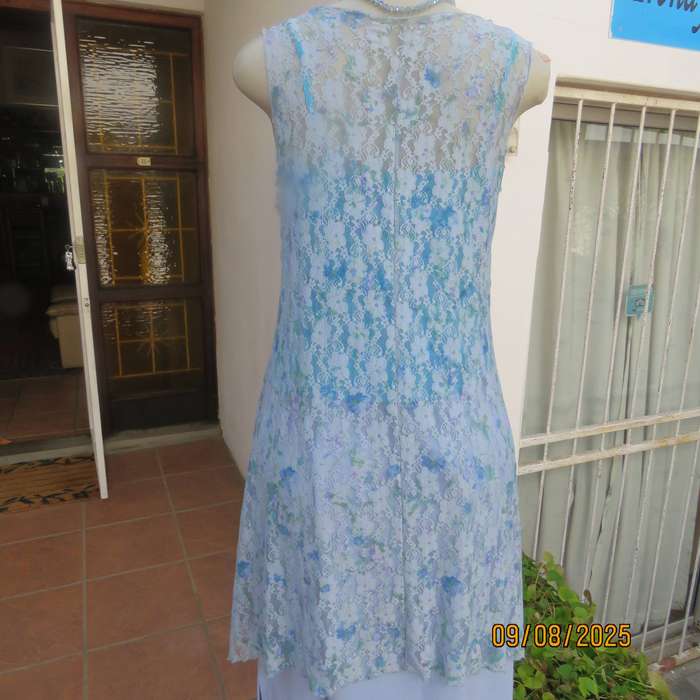Light blue stretch acrylic lace high-low long top in floral pattern size 36.