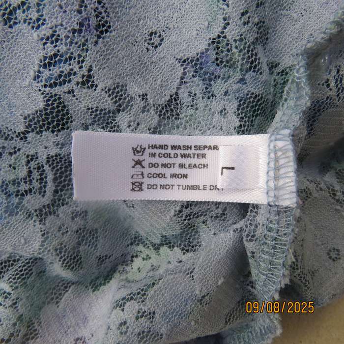 Light blue stretch acrylic lace high-low long top in floral pattern size 36.