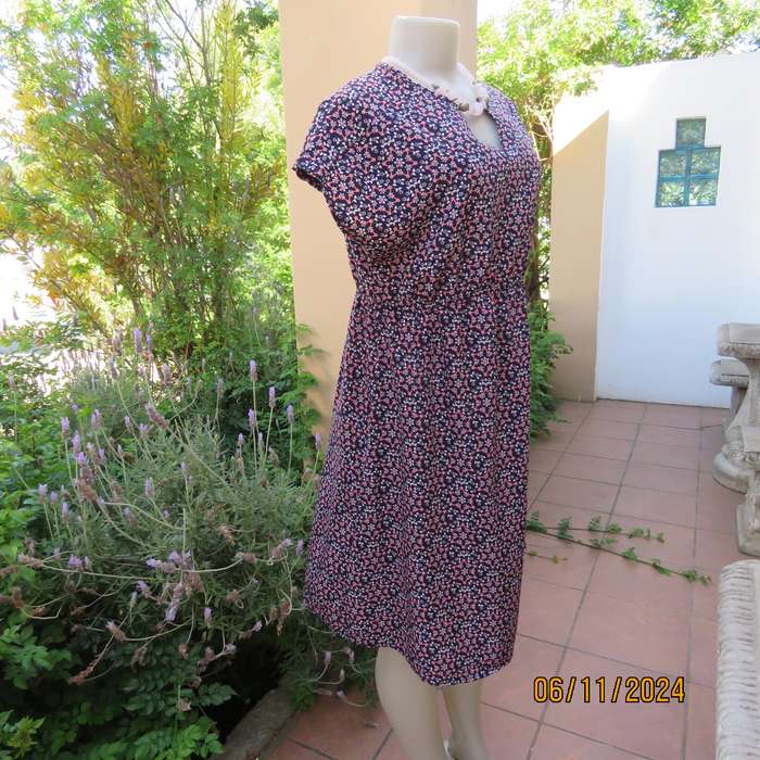Cool maternity empire style dress in poly-rayon blend.Navy with white-pink flowers.Size 32-34.As new