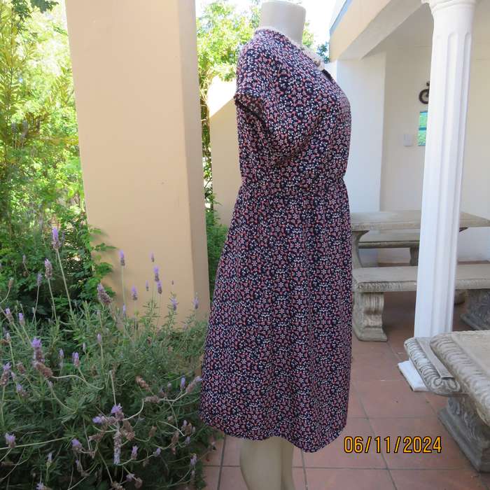 Cool maternity empire style dress in poly-rayon blend.Navy with white-pink flowers.Size 32-34.As new