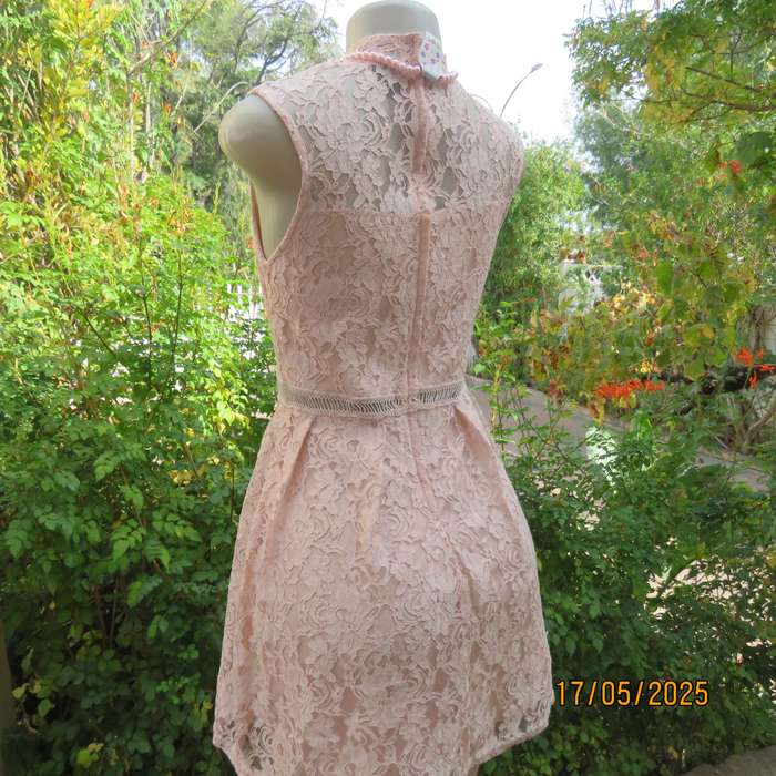 RT pale peach polyester lace mini dress with stretch poly lining. Size 32. Pleated bottom