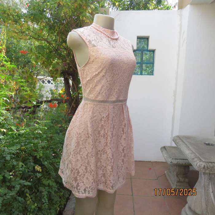 RT pale peach polyester lace mini dress with stretch poly lining. Size 32. Pleated bottom