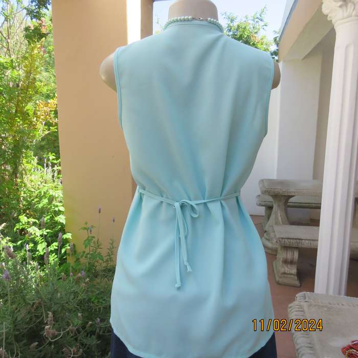 Look chic in this aqua colour sleeveless V neck top.Button down. Leaf embroidery.Size 34. As new