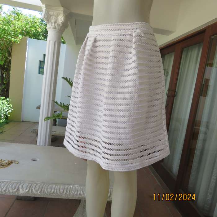 White 2 layer polyester lace knee length skirt size 36. With few knife pleats.