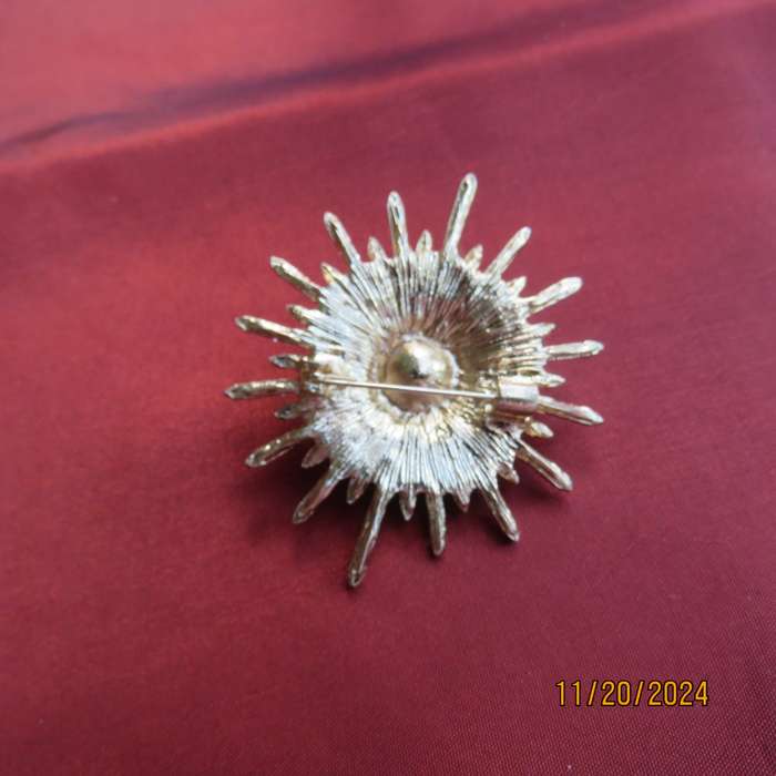 Unique shiny delicate brooch with lots of simulated diamonds on gold. Faux pearl in center.New item