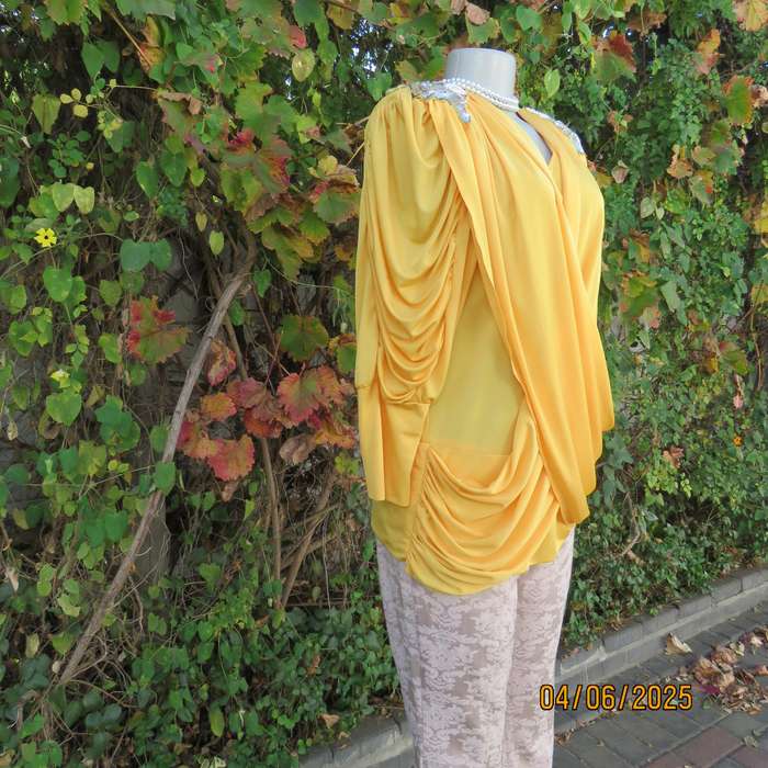 Buttercup yellow unique size 40 stretch polyester top. Crossover overlays. Shoulder decoration.