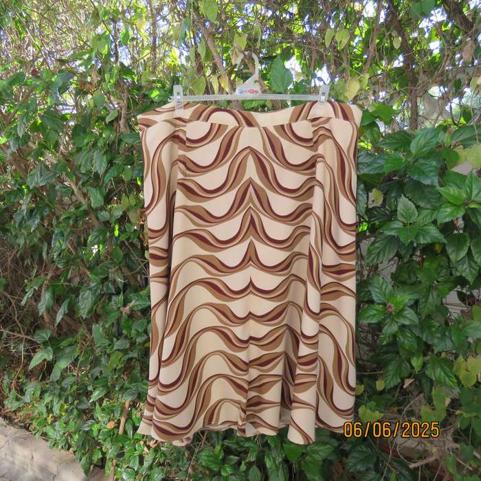 Graphic printed rich cream fully lined polyester A-Line skirt. Brown-tan print. Size 50