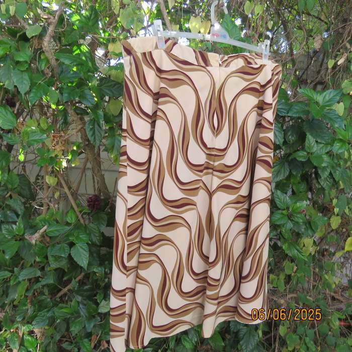 Graphic printed rich cream fully lined polyester A-Line skirt. Brown-tan print. Size 50