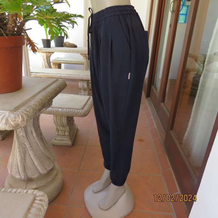 Comfy wide cut navy polyester pants size 38. Front pleats.Elasticated waist -leg hems. Drawstring.