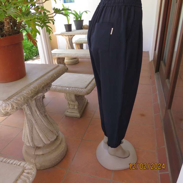 Comfy wide cut navy polyester pants size 38. Front pleats.Elasticated waist -leg hems. Drawstring.