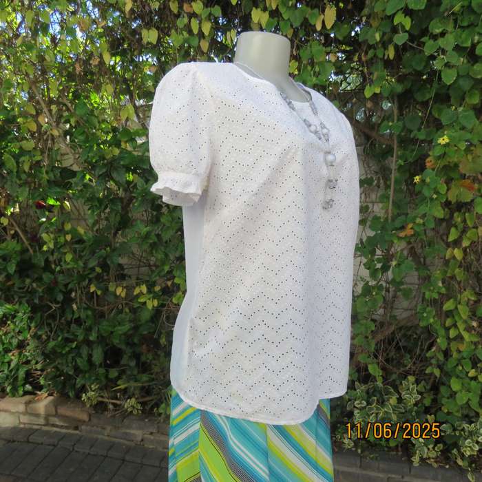 White cotton slip over top. Front and sleeves with eyelet embroidery. Size 36