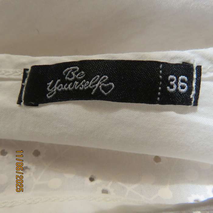 White cotton slip over top. Front and sleeves with eyelet embroidery. Size 36