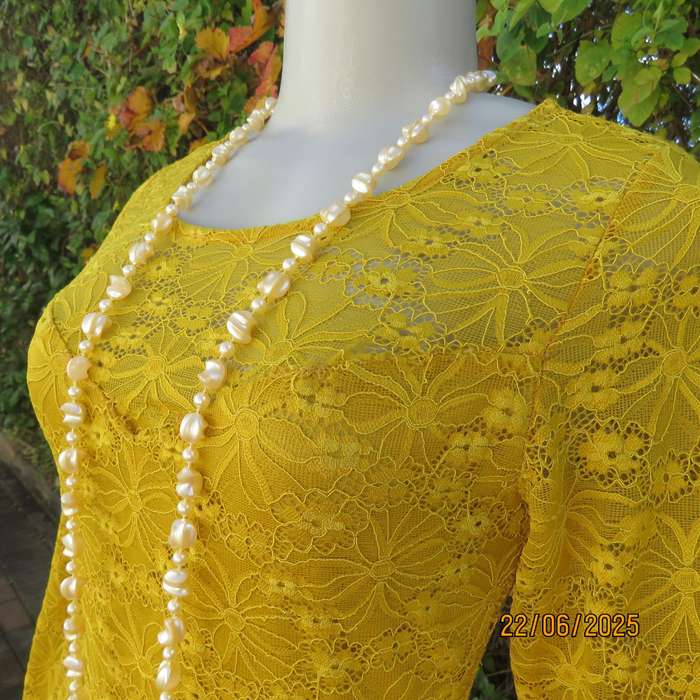 NEW FEELING mustard stretch polyester lace peplum top. Size 32. Long sleeves.