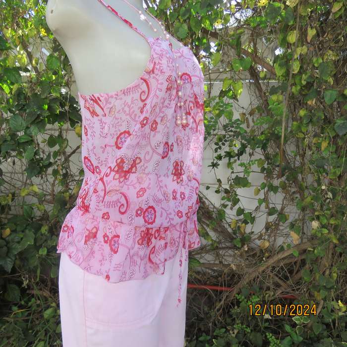 Chic slightly creased polyester pink top/red patterns. Size 34. Peplum frill.Drawstring waist.As new