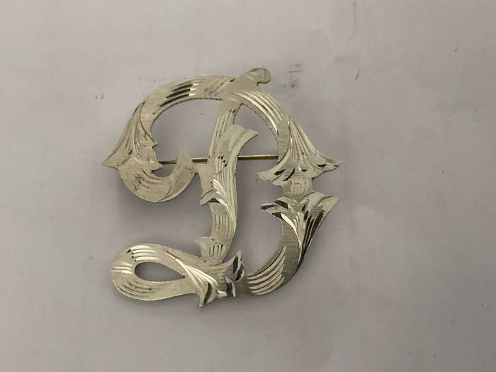 A beautiful sterling silver monogram D brooch made in mexico