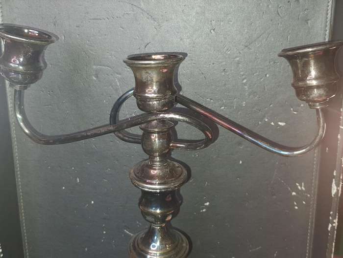 A VINTAGE THREE-CANDLE HOLDER EPNS CANDLE LIBRA STAND